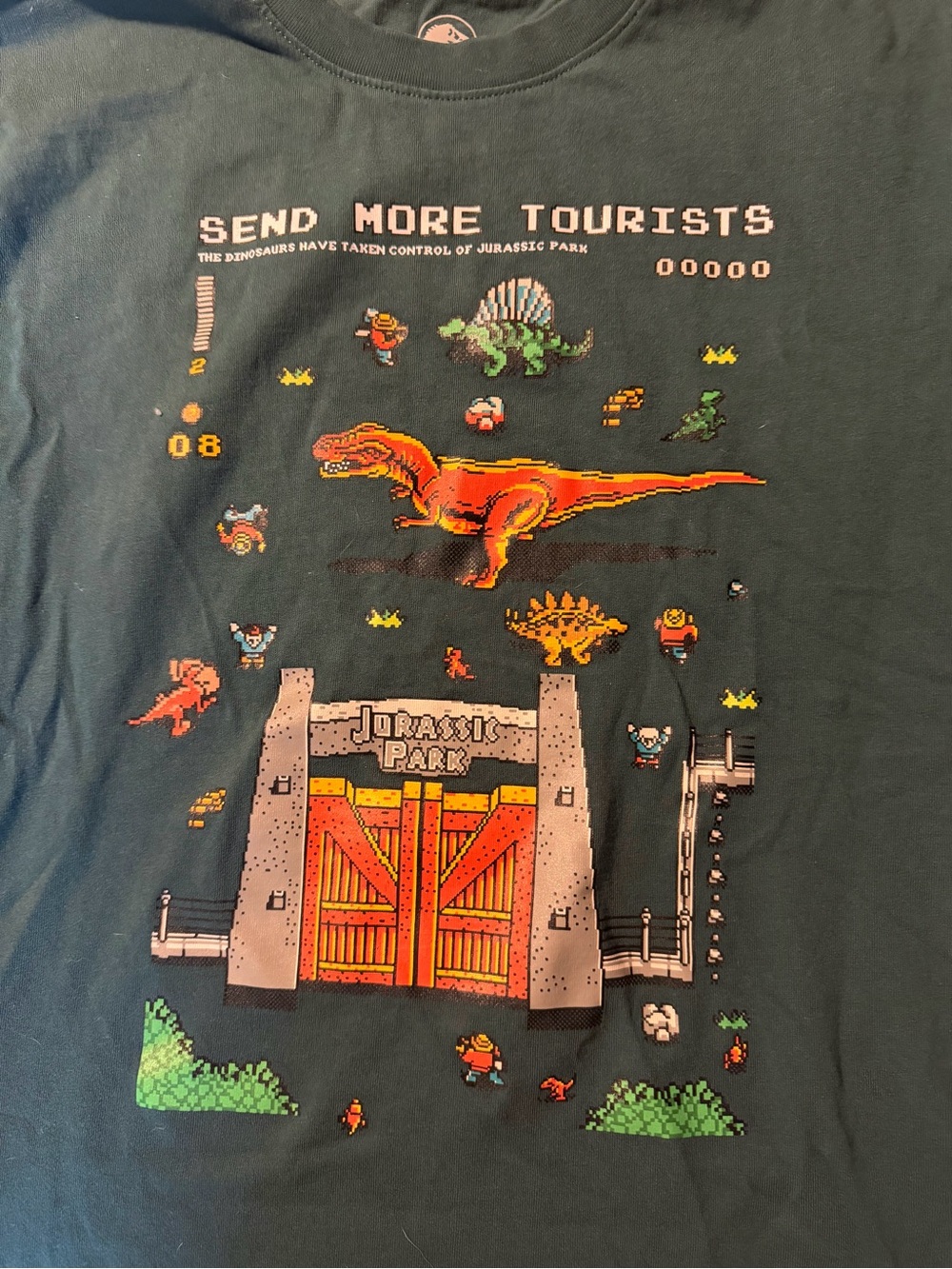 Jurassic Park 'Send More Tourists' Dark Green Pixel Art Graphic Tee